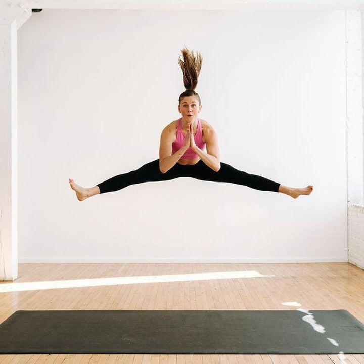 Dynamic jump pose on Gorilla Mat in studio